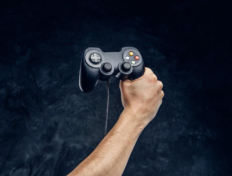 video-game-console-controller-gamer-hand-against-background-dark-wall_613910-20291